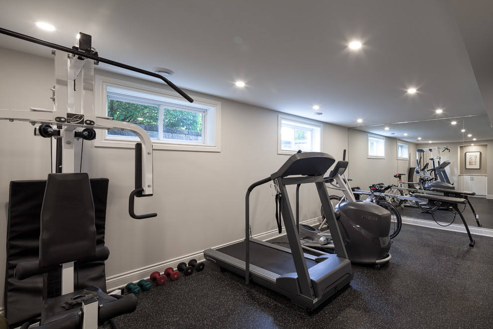 Design ideas for a mid-sized modern home weight room in Ottawa with beige walls.