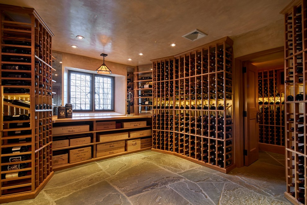 Photo of a traditional wine cellar in New York with storage racks and grey floor.