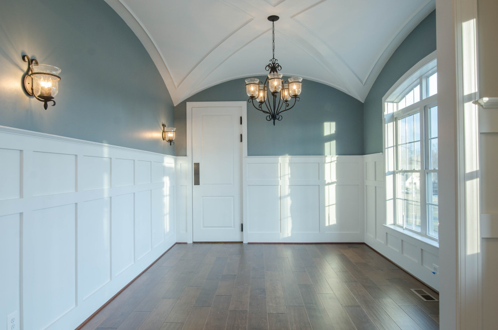 Inspiration for a traditional kitchen/dining combo in Baltimore with blue walls, medium hardwood floors, brown floor, vaulted and decorative wall panelling.