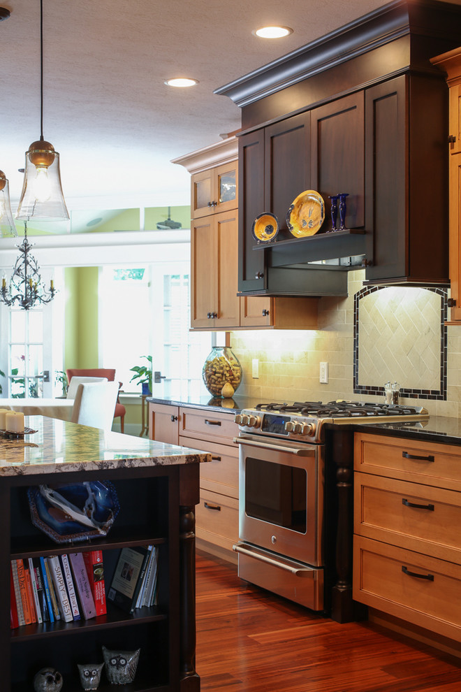 Example of a huge transitional medium tone wood floor kitchen design with an undermount sink, shaker cabinets, light wood cabinets, granite countertops, beige backsplash, porcelain backsplash, stainless steel appliances and an island