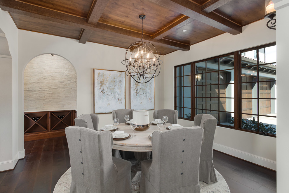 Photo of a mediterranean separate dining room in Seattle with white walls, dark hardwood floors and no fireplace.