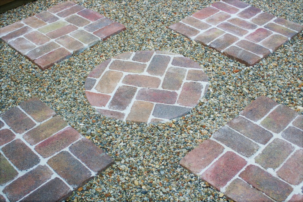 Inspiration for a mid-sized country front yard partial sun garden for summer in Auckland with brick pavers.