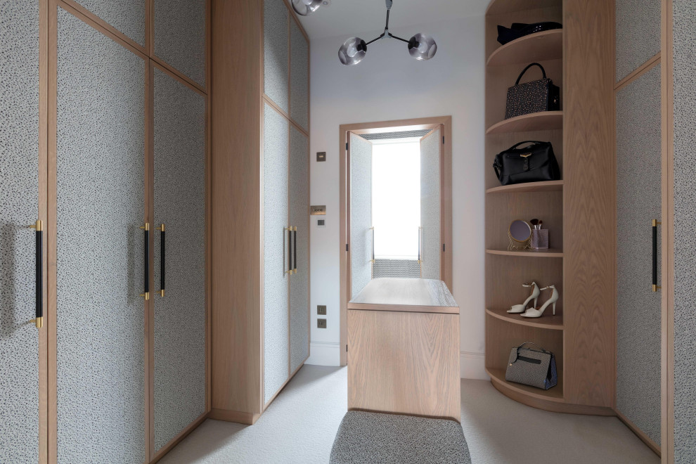 Design ideas for a contemporary walk-in wardrobe for women in Other with flat-panel cabinets, grey cabinets, carpet and grey floors.