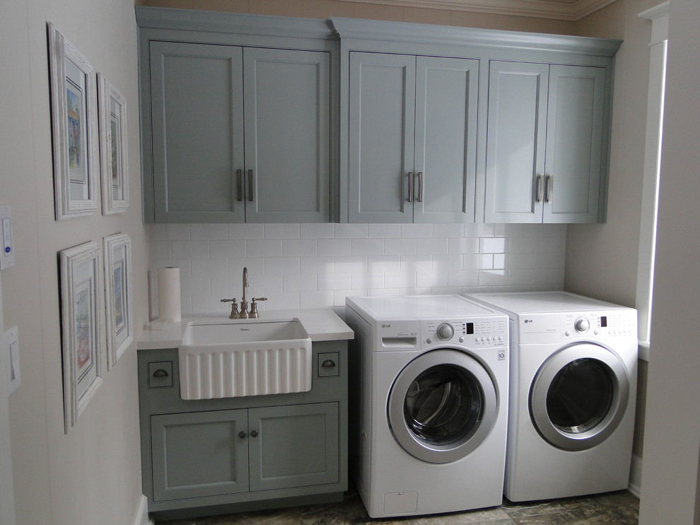 Mid-sized traditional single-wall dedicated laundry room in Toronto with a farmhouse sink, quartz benchtops, grey walls, marble floors, a side-by-side washer and dryer, shaker cabinets and grey cabinets.