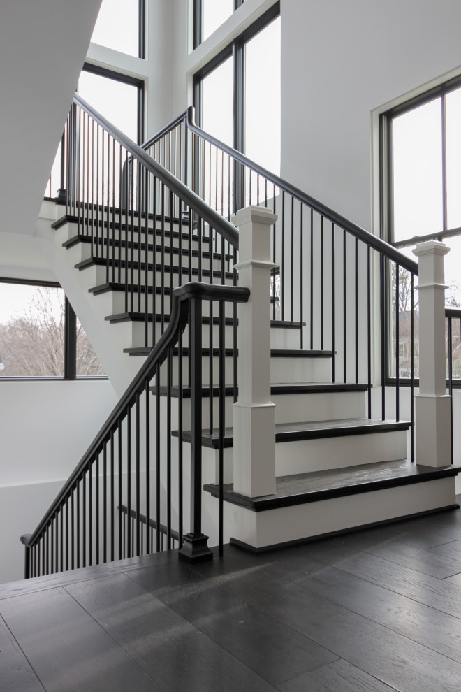 Inspiration for a large transitional wooden floating mixed material railing and wall paneling staircase remodel in DC Metro with wooden risers