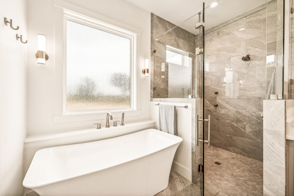 Freestanding bathtub - mid-sized transitional gray tile and porcelain tile porcelain tile, gray floor and double-sink freestanding bathtub idea with shaker cabinets, gray cabinets, a two-piece toilet, white walls, an undermount sink, quartz countertops, a hinged shower door, white countertops and a built-in vanity