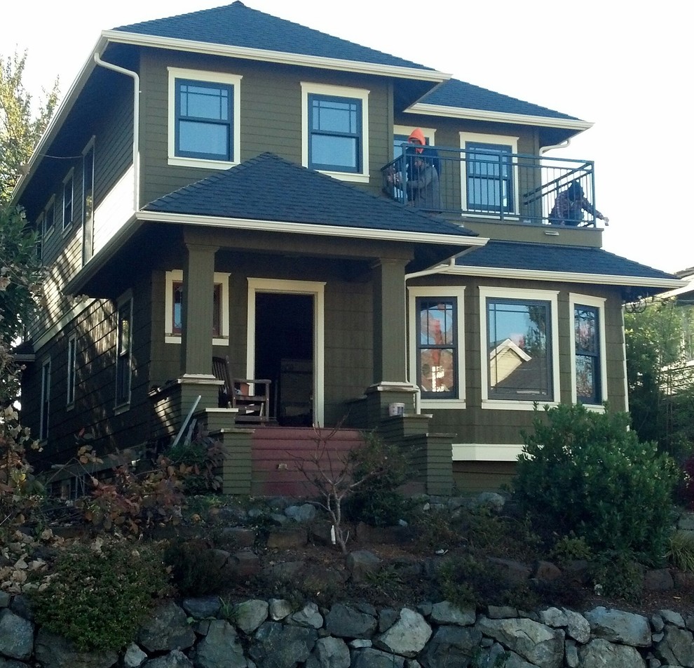 Inspiration for a large arts and crafts two-storey green exterior in Seattle with concrete fiberboard siding and a hip roof.