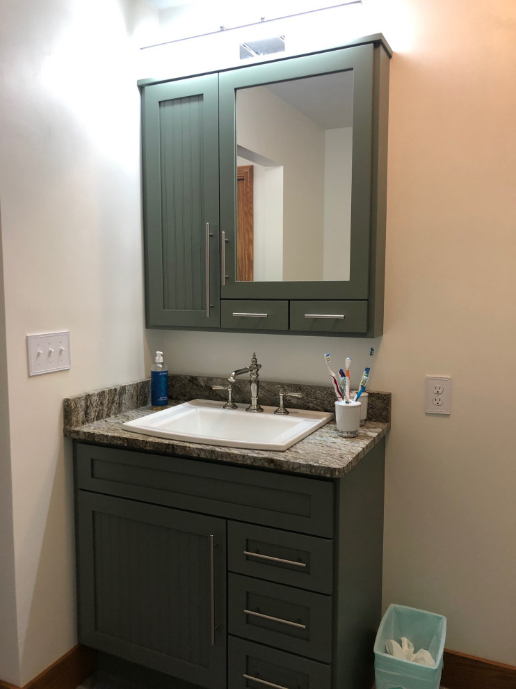 Inspiration for a small country bathroom in Other with beaded inset cabinets, green cabinets, beige walls, vinyl floors, a drop-in sink, granite benchtops, grey floor, brown benchtops, a single vanity and a freestanding vanity.