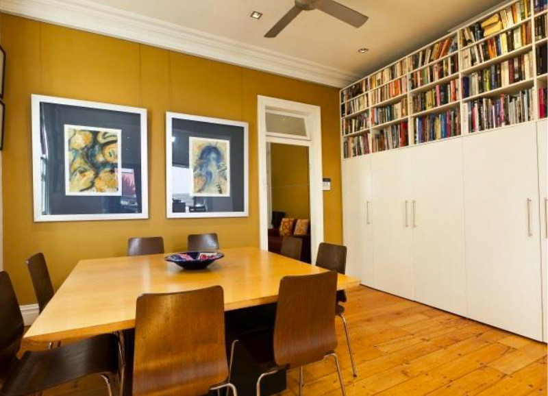 Design ideas for a contemporary dining room in Sydney with yellow walls and medium hardwood floors.