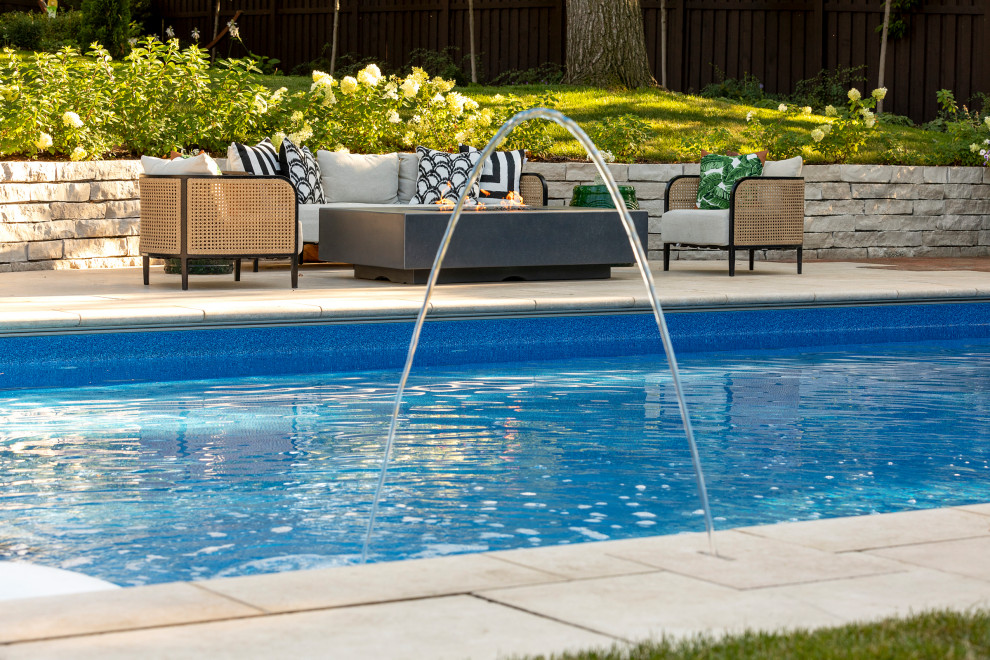 Pool landscaping - large craftsman backyard stone and rectangular natural pool landscaping idea in Minneapolis