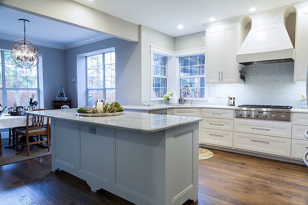 Inspiration for a mid-sized transitional kitchen in Dallas with a double-bowl sink, recessed-panel cabinets, white cabinets, quartzite benchtops, blue splashback, stainless steel appliances, dark hardwood floors, with island and glass tile splashback.