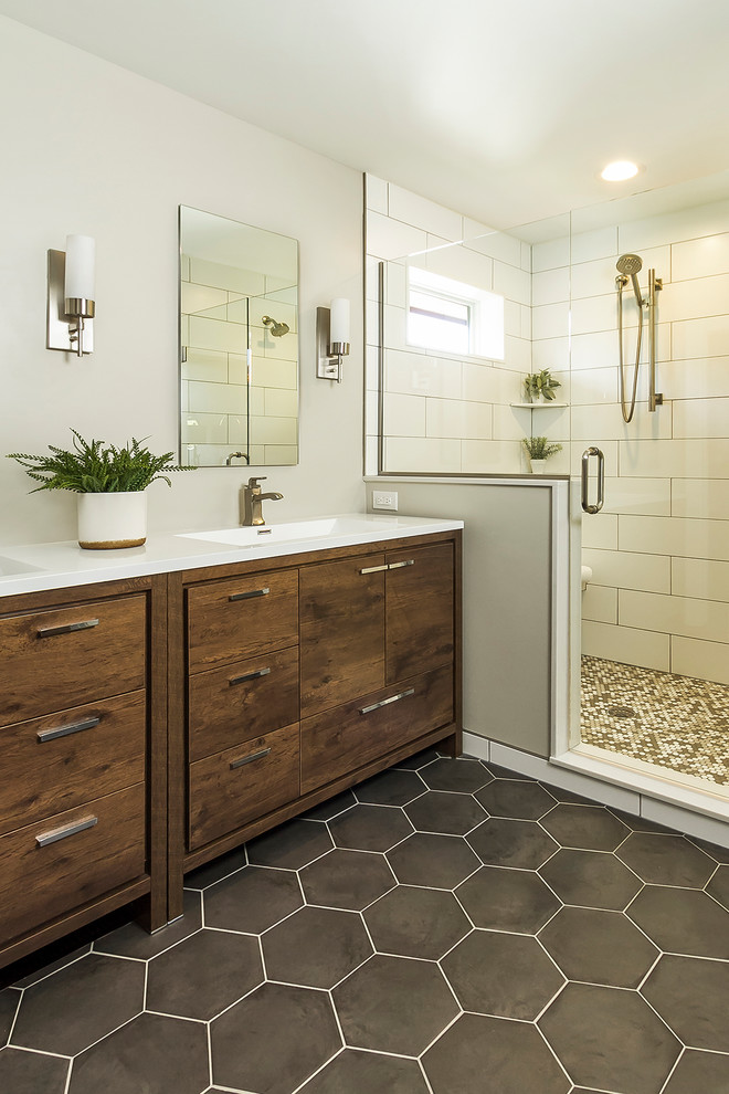 Photo of a mid-sized transitional master bathroom in Minneapolis with dark wood cabinets, white tile, subway tile, grey walls, porcelain floors, an undermount sink, quartzite benchtops, grey floor, a hinged shower door, white benchtops and flat-panel cabinets.