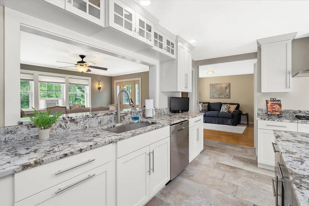 This is an example of a large transitional u-shaped separate kitchen in Boston with shaker cabinets, white cabinets, granite benchtops, stainless steel appliances, with island and grey benchtop.