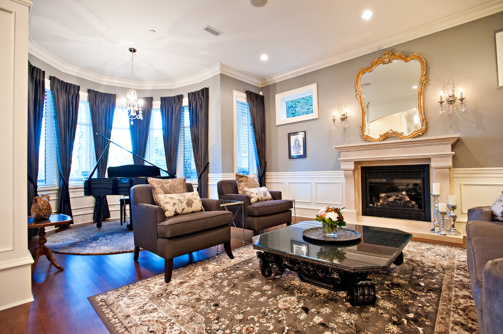 Inspiration for a large traditional enclosed living room in Vancouver with a music area, grey walls, dark hardwood floors, a standard fireplace, a stone fireplace surround, no tv and brown floor.