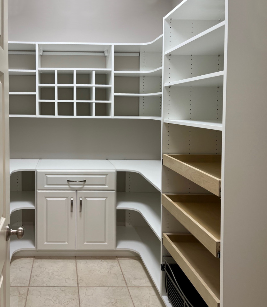 Design ideas for a mid-sized transitional gender-neutral storage and wardrobe in Cleveland with raised-panel cabinets, white cabinets and linoleum floors.