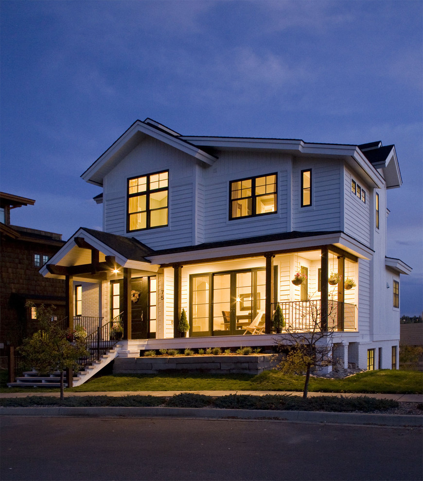 Design ideas for a country two-storey exterior in Denver with wood siding.
