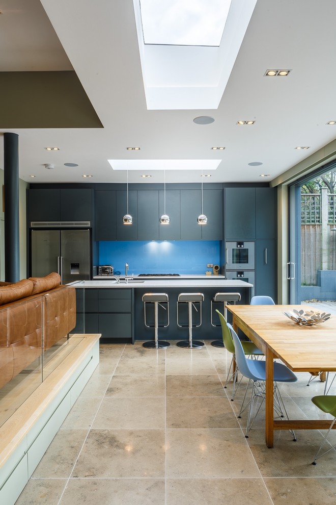 This is an example of a contemporary kitchen/dining combo in London with grey walls.