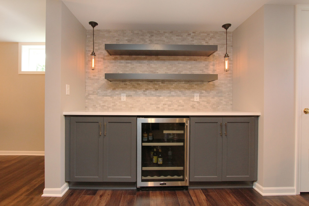 Large minimalist look-out basement photo in Grand Rapids with gray walls