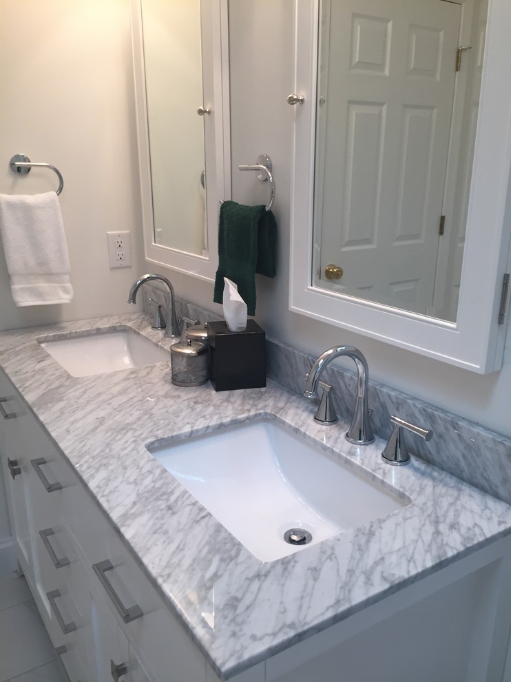 Mid-sized transitional gray tile and porcelain tile porcelain tile home design photo in Indianapolis with flat-panel cabinets, white cabinets, a one-piece toilet, white walls, an undermount sink and marble countertops