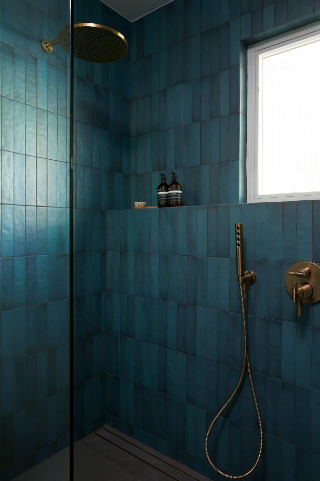 Small midcentury bathroom in San Francisco with a built-in shower, a one-piece toilet, blue tiles, ceramic tiles, blue walls, ceramic flooring, a wall-mounted sink, limestone worktops, grey floors, a hinged door, black worktops, a single sink, a floating vanity unit and exposed beams.