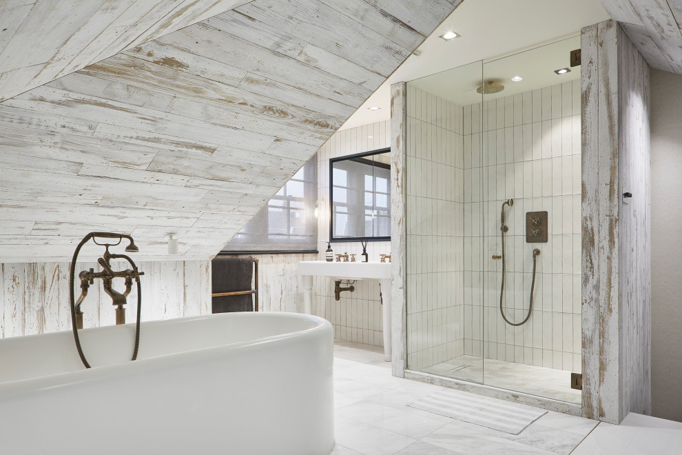 Modern bathroom in London with a freestanding tub, a curbless shower, white tile, wood-look tile, white walls, a sliding shower screen, a double vanity and wood walls.