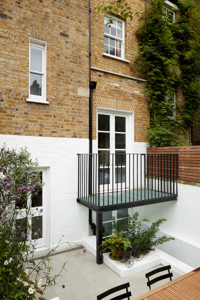 Inspiration for a small traditional balcony in London with no cover and metal railing.