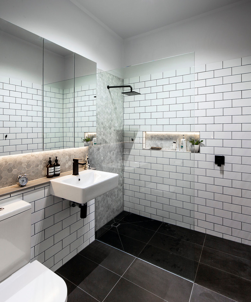 Contemporary bathroom in Melbourne with a wall-mount sink, white tile, subway tile and a curbless shower.