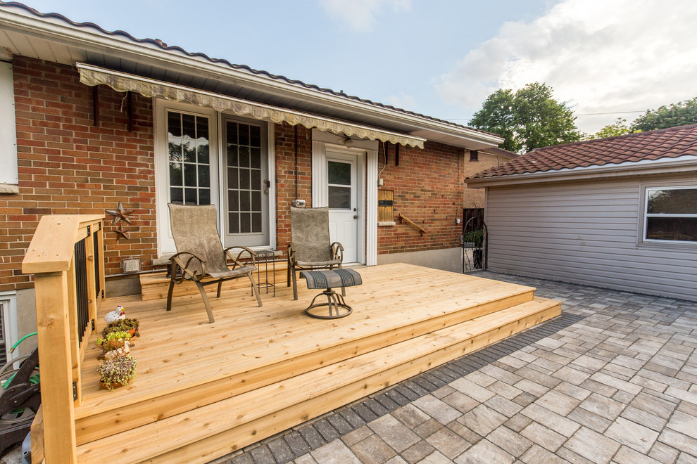 Design ideas for a mid-sized traditional backyard patio in Toronto with decking and no cover.