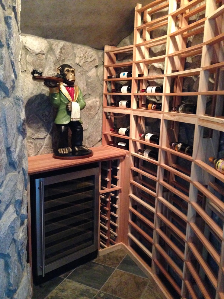This is an example of a small traditional wine cellar in Charlotte with slate floors and storage racks.