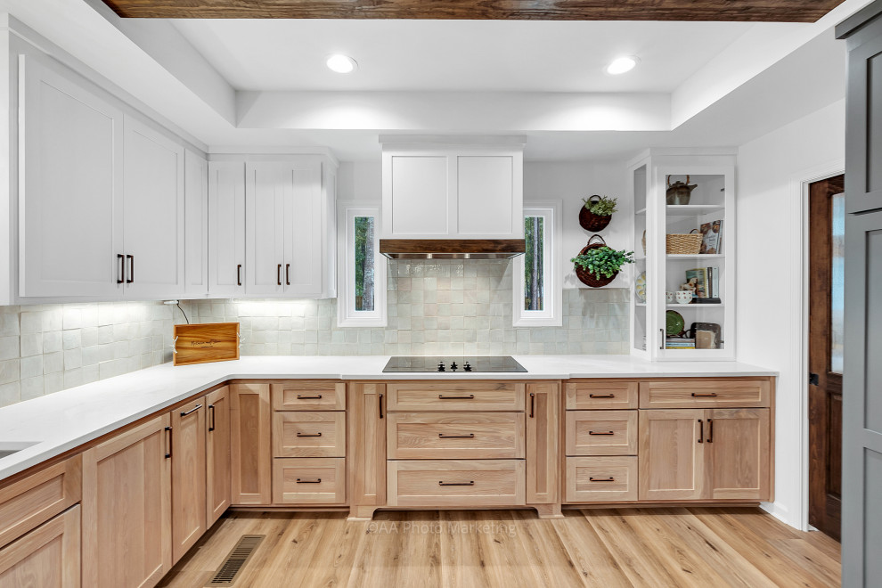 Inspiration for a large country u-shaped eat-in kitchen in Atlanta with shaker cabinets, light wood cabinets, quartzite benchtops, white splashback, ceramic splashback, vinyl floors, white benchtop and recessed.