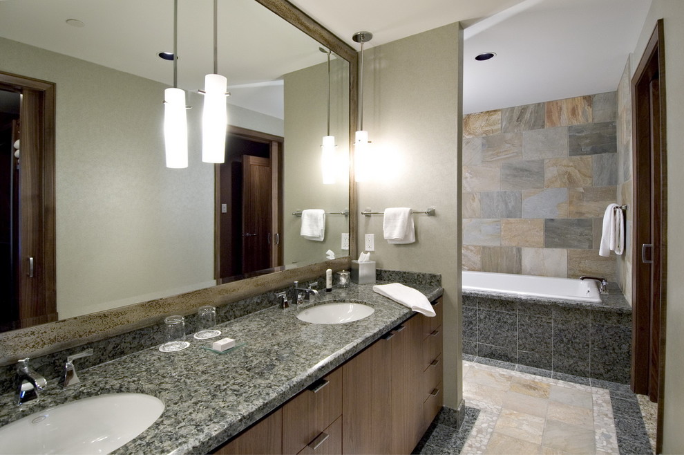 Design ideas for a contemporary bathroom in Vancouver with an undermount sink, flat-panel cabinets, medium wood cabinets, a drop-in tub, multi-coloured tile and slate.
