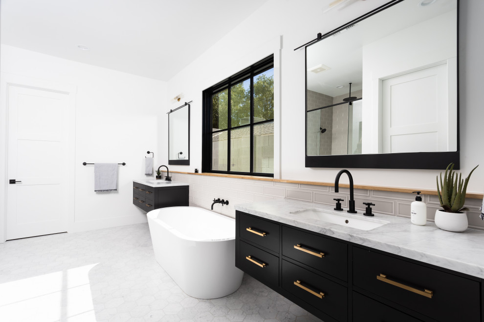 Inspiration for a country bathroom in Phoenix with black cabinets, a freestanding tub, white walls and a double vanity.