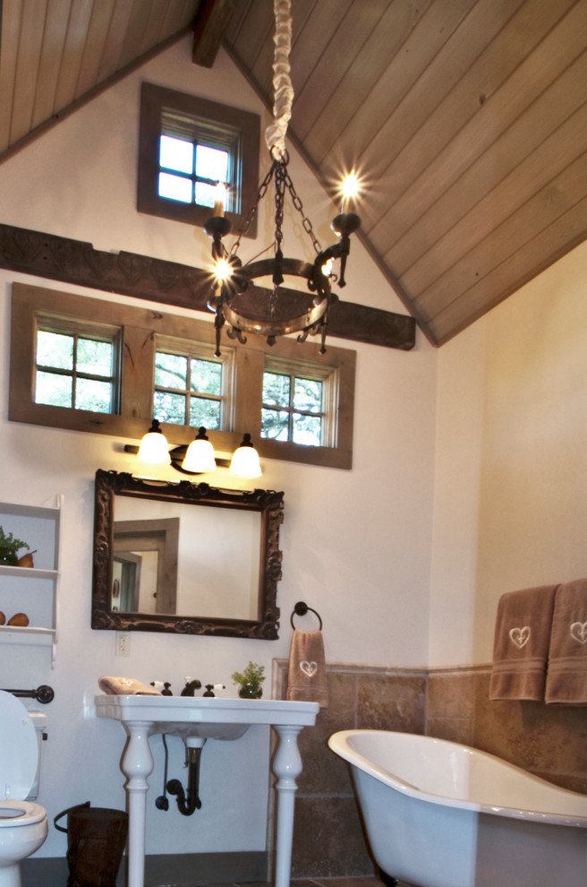 Design ideas for an eclectic master bathroom in Austin with a freestanding tub, a two-piece toilet, beige tile, white walls and a wall-mount sink.