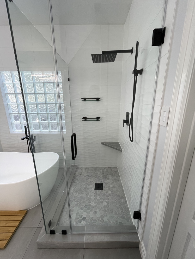 Photo of a large contemporary ensuite bathroom in Houston with flat-panel cabinets, a freestanding bath, a corner shower, white tiles, porcelain tiles, engineered stone worktops, grey floors, white worktops and a built in vanity unit.