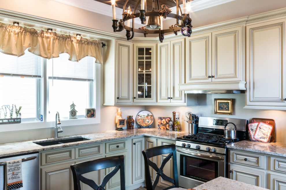 Inspiration for a large l-shaped eat-in kitchen remodel with an undermount sink, raised-panel cabinets, white cabinets, granite countertops, stainless steel appliances, an island and white countertops