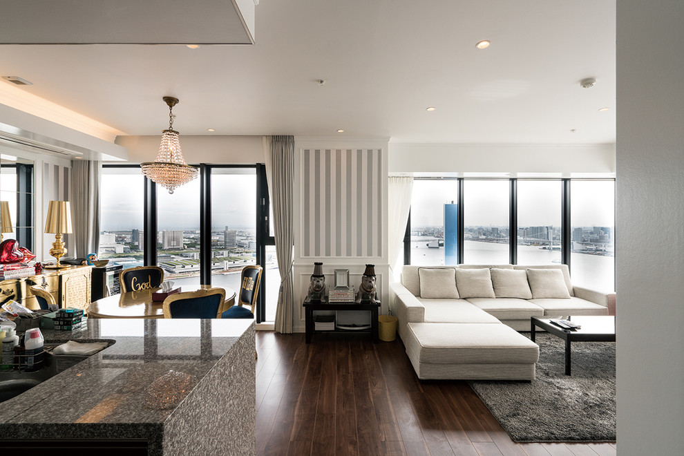Photo of an eclectic living room in Tokyo with white walls, dark hardwood floors and brown floor.