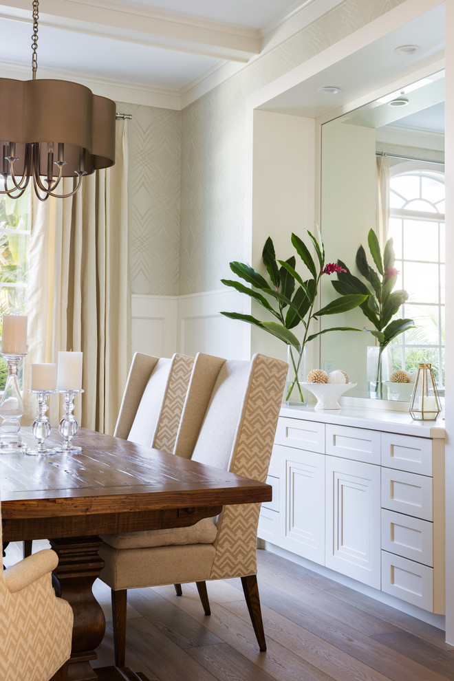 This is an example of a large beach style dining room in Miami with beige walls and light hardwood floors.