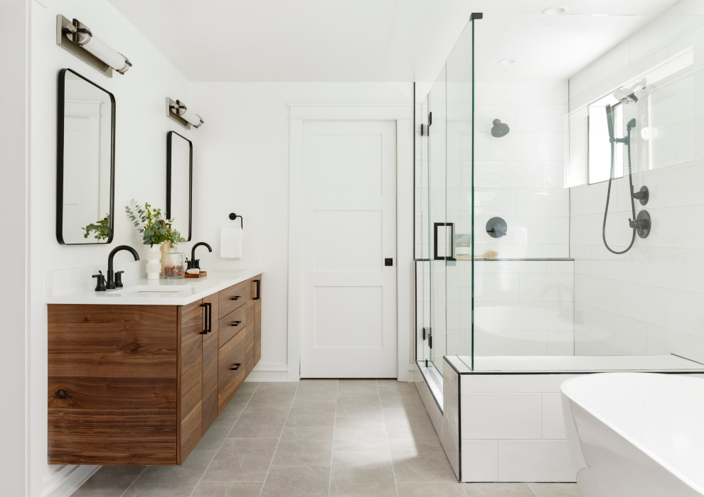 Design ideas for a large country master bathroom in Portland with flat-panel cabinets, medium wood cabinets, a freestanding tub, a double shower, a two-piece toilet, white tile, ceramic tile, white walls, porcelain floors, an undermount sink, engineered quartz benchtops, grey floor, a hinged shower door, white benchtops, a shower seat, a double vanity and a floating vanity.