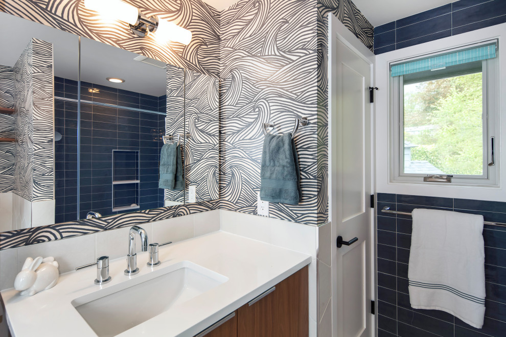 Example of a mid-sized trendy kids' blue tile and porcelain tile porcelain tile, beige floor, single-sink and wallpaper bathroom design in Seattle with flat-panel cabinets, dark wood cabinets, blue walls, an undermount sink, quartz countertops, white countertops and a floating vanity