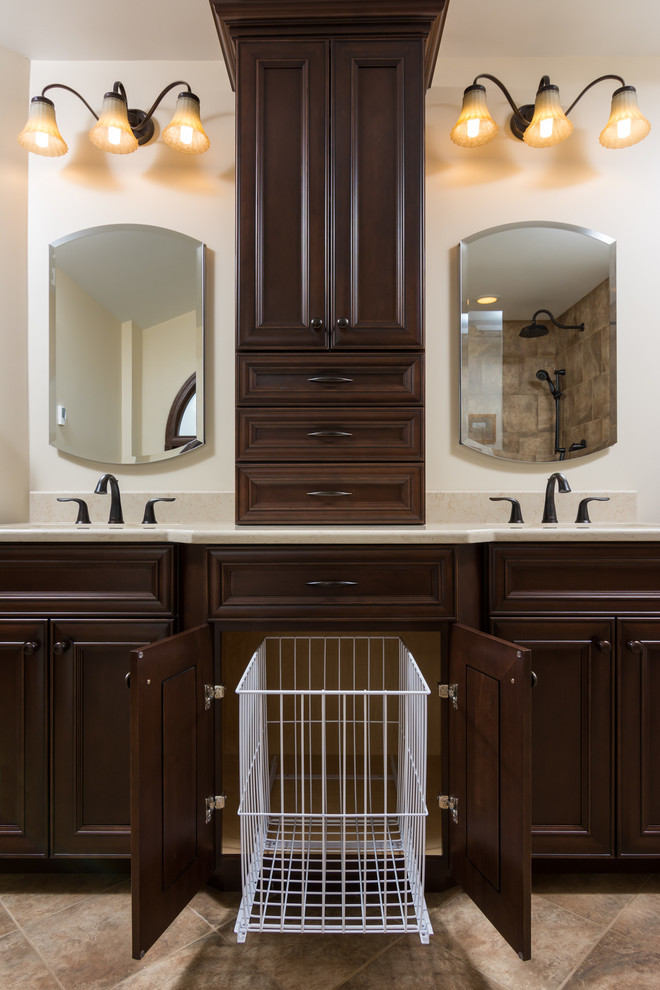 This is an example of a large traditional master bathroom in Detroit with flat-panel cabinets, dark wood cabinets, a freestanding tub, an alcove shower, a two-piece toilet, beige tile, stone tile, beige walls, an undermount sink, engineered quartz benchtops, brown floor and a hinged shower door.