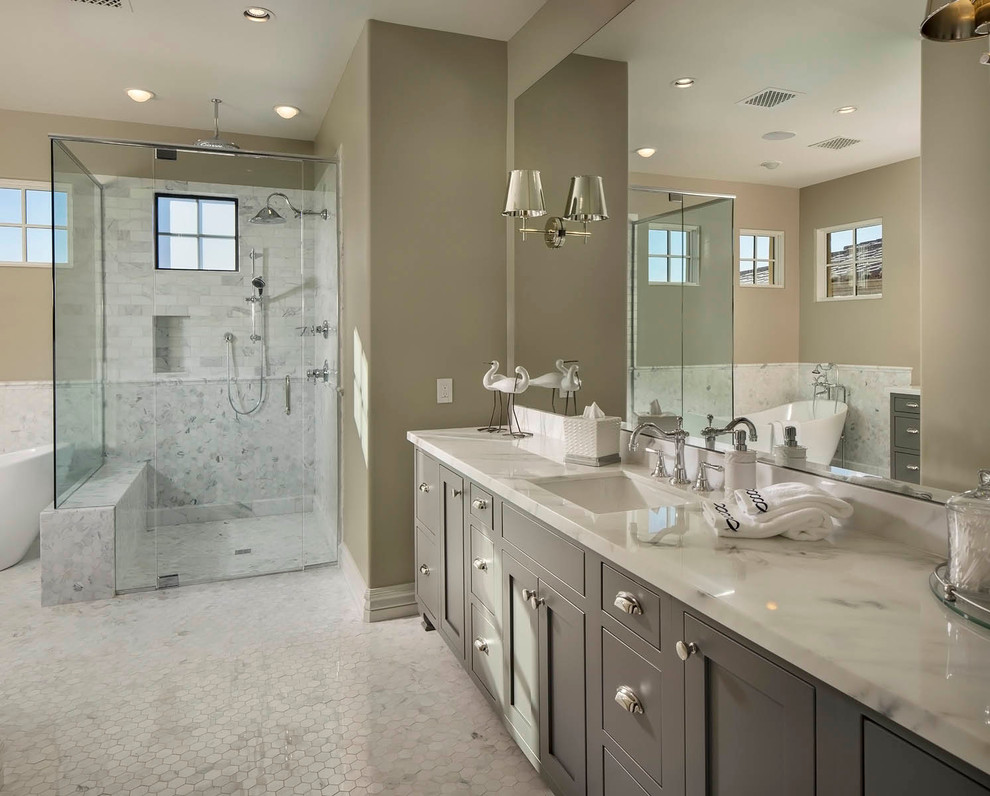 Inspiration for a transitional bathroom in Phoenix with grey cabinets, a freestanding tub, white tile, marble benchtops, shaker cabinets, grey walls and an undermount sink.