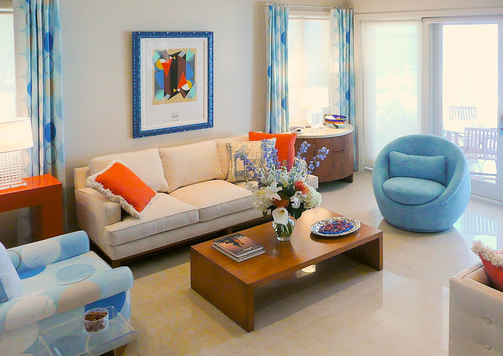 Inspiration for a mid-sized eclectic open concept living room in Miami with beige walls and porcelain floors.