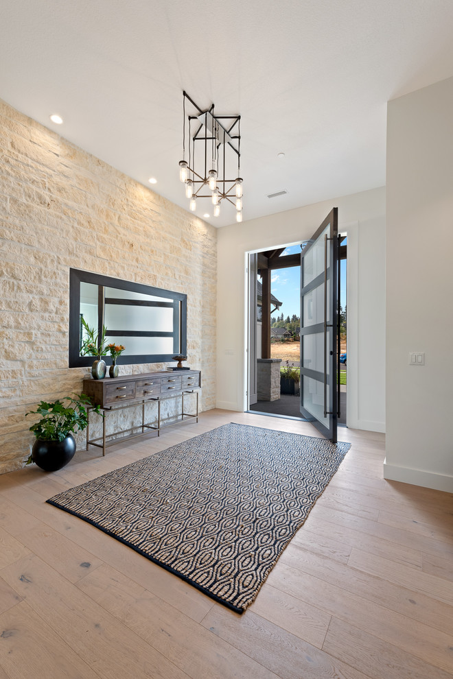 Transitional light wood floor and beige floor pivot front door photo in Portland with white walls and a black front door