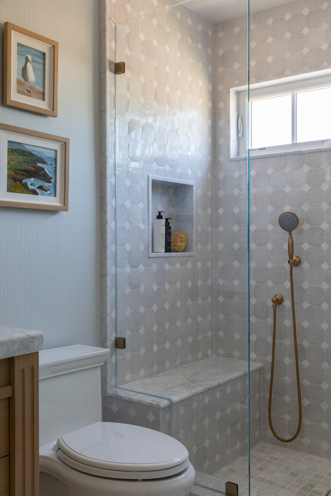 Example of a beach style white floor, single-sink and wallpaper bathroom design in Orange County with blue walls, a hinged shower door, white countertops and a built-in vanity