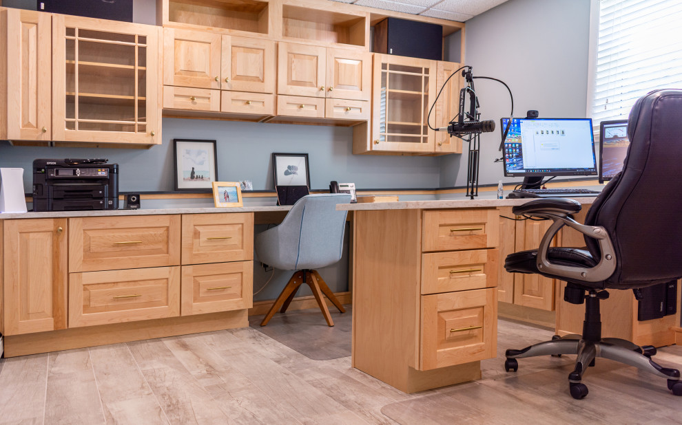 This is an example of a mid-sized arts and crafts home studio in New York with blue walls, porcelain floors, a built-in desk, beige floor and recessed.