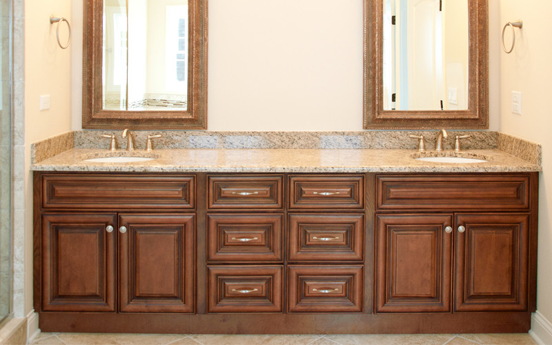 Mid-sized traditional master bathroom in Atlanta with an undermount sink, raised-panel cabinets, medium wood cabinets, granite benchtops, a drop-in tub, an open shower, a two-piece toilet, brown tile, ceramic tile, beige walls and medium hardwood floors.
