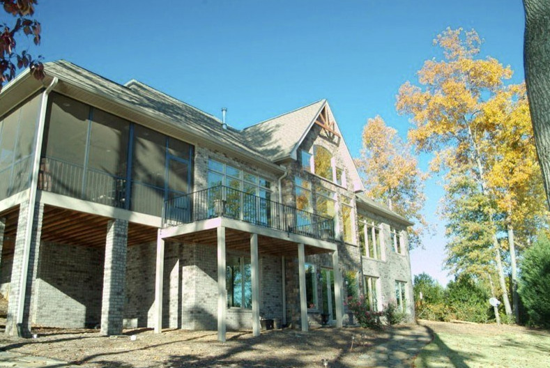 Inspiration for a large transitional beige two-story brick exterior home remodel