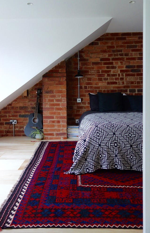 This is an example of a mid-sized scandinavian guest bedroom in Kent with white walls, plywood floors and no fireplace.