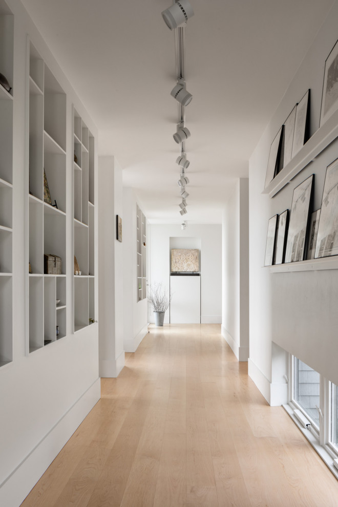 This is an example of a contemporary hallway in Other with white walls.