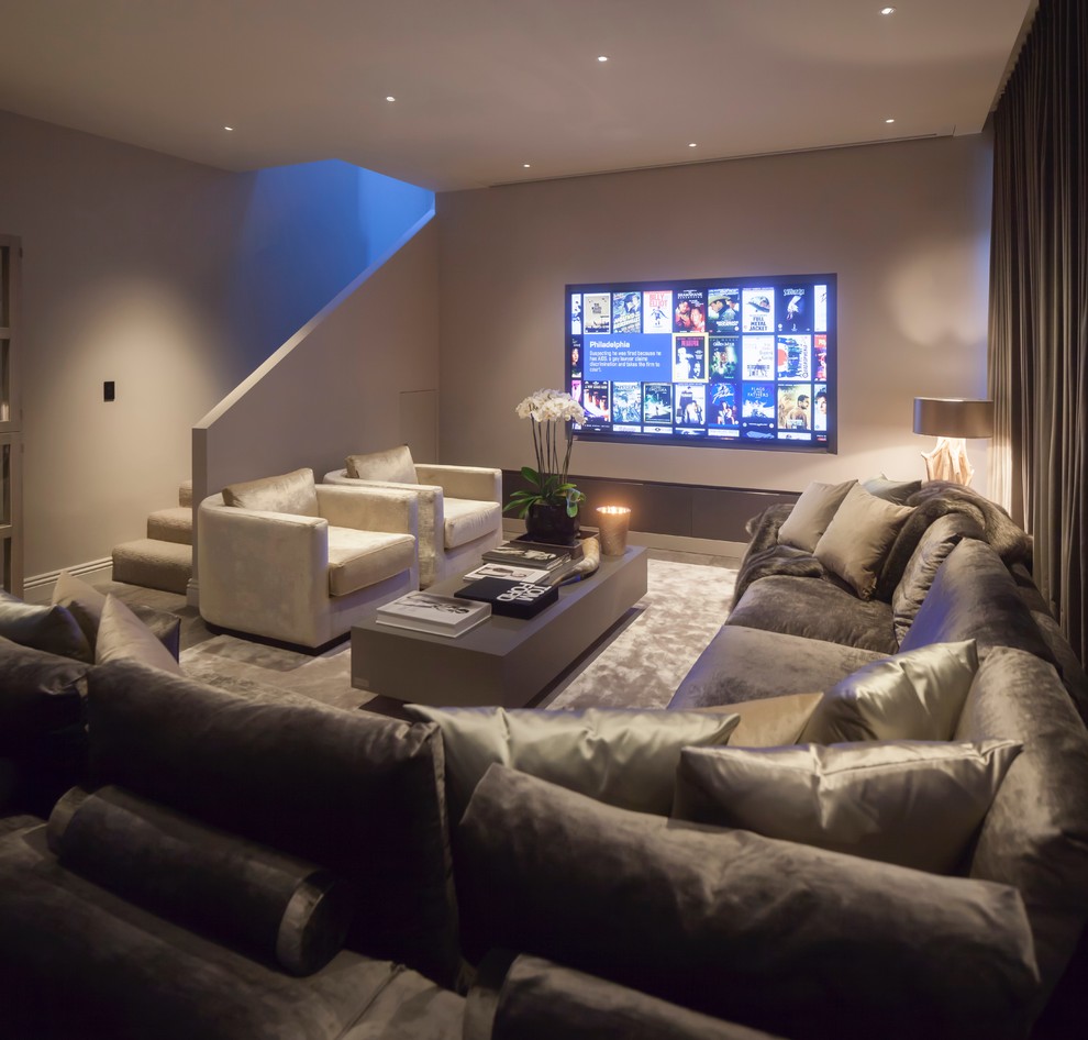 Large contemporary open concept home theatre in West Midlands with grey walls, ceramic floors and a projector screen.